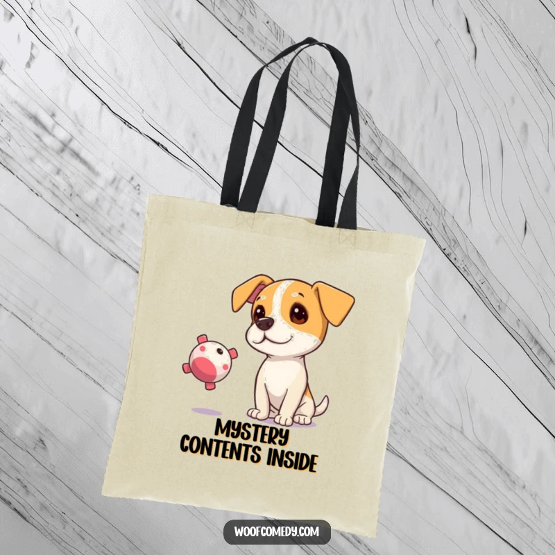 Funny tote bag showcasing a curious dog tilting its head, eyes fixed on a floating squeaky toy.